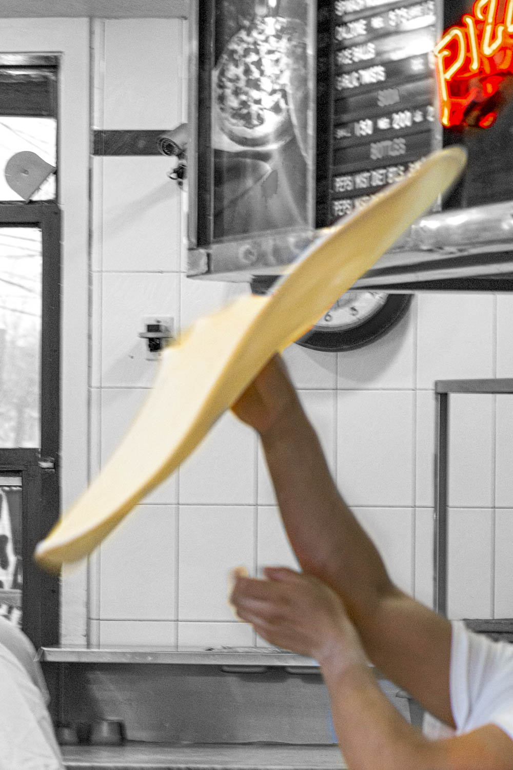 Pizza maker tossing dough